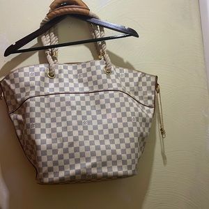 Louis Vuitton rope handle leather. It also comes with a matching cosmetic bag.